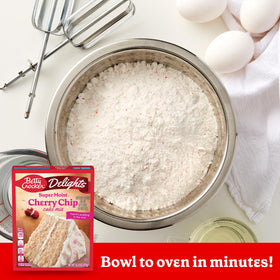 Cake rising in oven using Betty Crocker mix for an easy dessert.