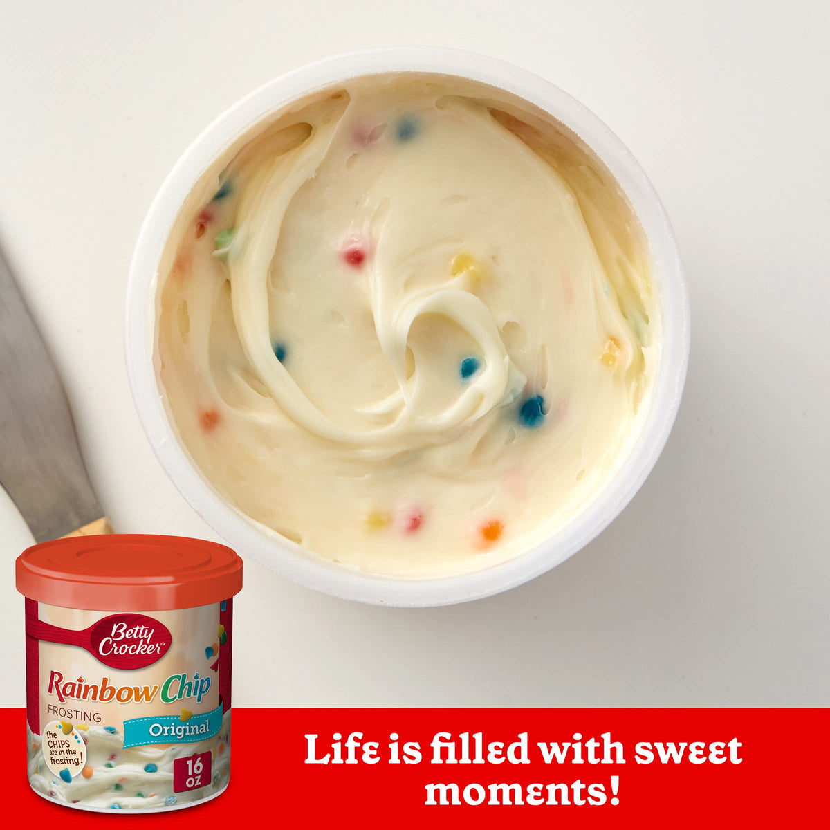 Betty Crocker Rainbow Chip Frosting on a cake for a festive finish.