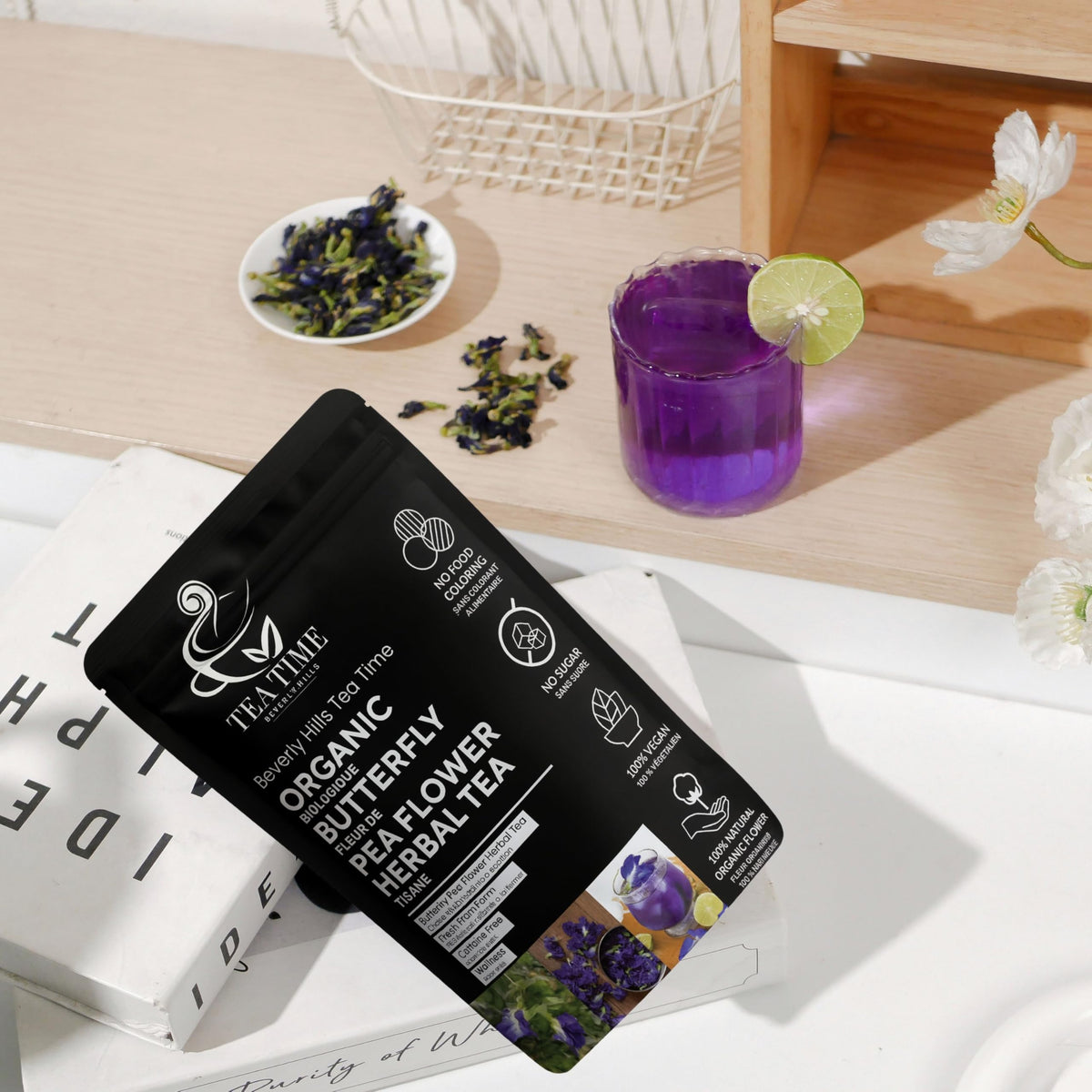 Beverly Hills Tea Time brewed butterfly pea tea pour shows vivid blue-to-purple transition with a splash of citrus.