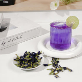 Beverly Hills Tea Time iced butterfly pea tea glass highlights refreshing aroma and color.