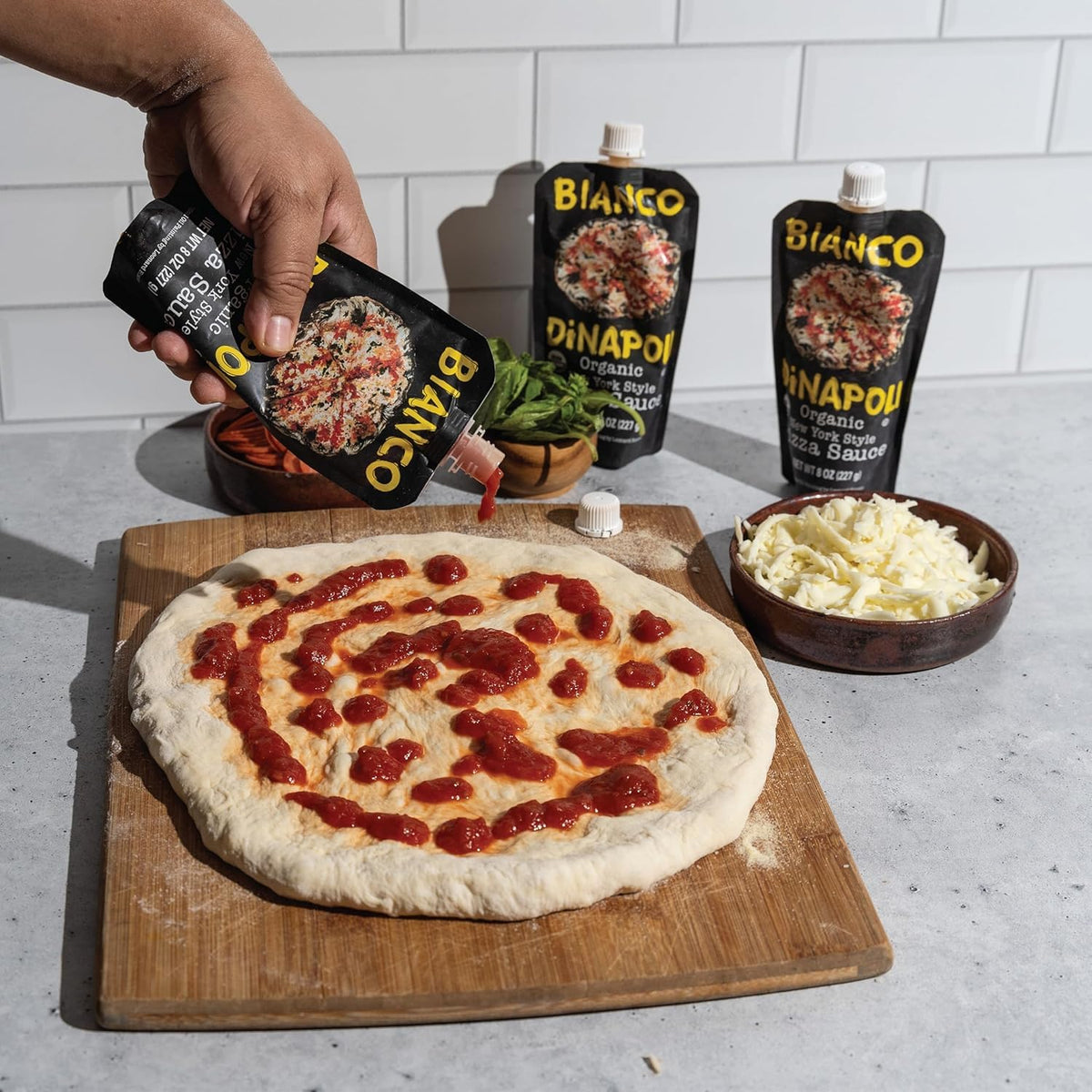 Bianco DiNapoli homemade-pizza-night evokes cozy dinner and customizable toppings.