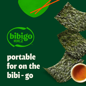Bibigo Seaweed Snack hand holding a single crisp sheet.