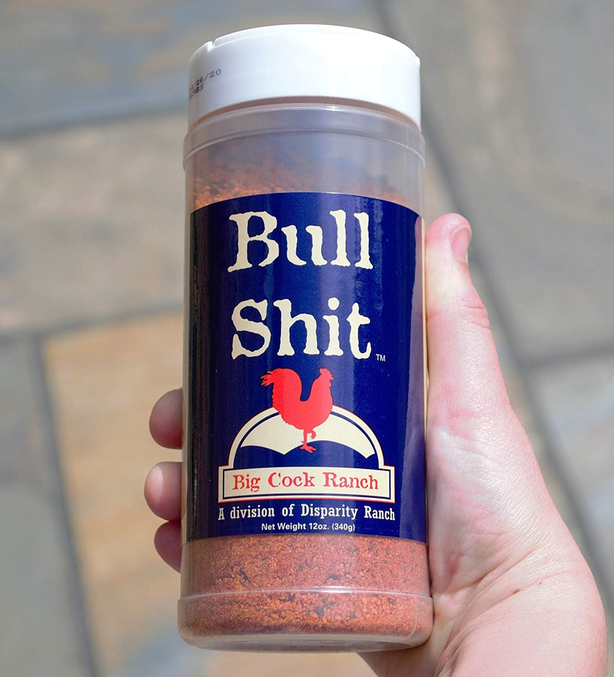 Big Cock Ranch Bullshit steak seasoning on ribeye ready to grill enhances beef flavor.