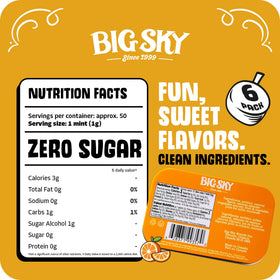 BIG SKY Orange & Crème Mints tin open — creamy centers for quick refreshment.