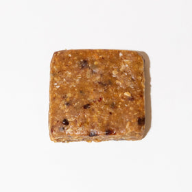 Big Spoon Roasters nut butter bars closeup reveals nuts and chocolate bits for flavor-packed bite.