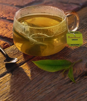Cup with Constant Comment Green Tea brewing for a flavorful hot drink