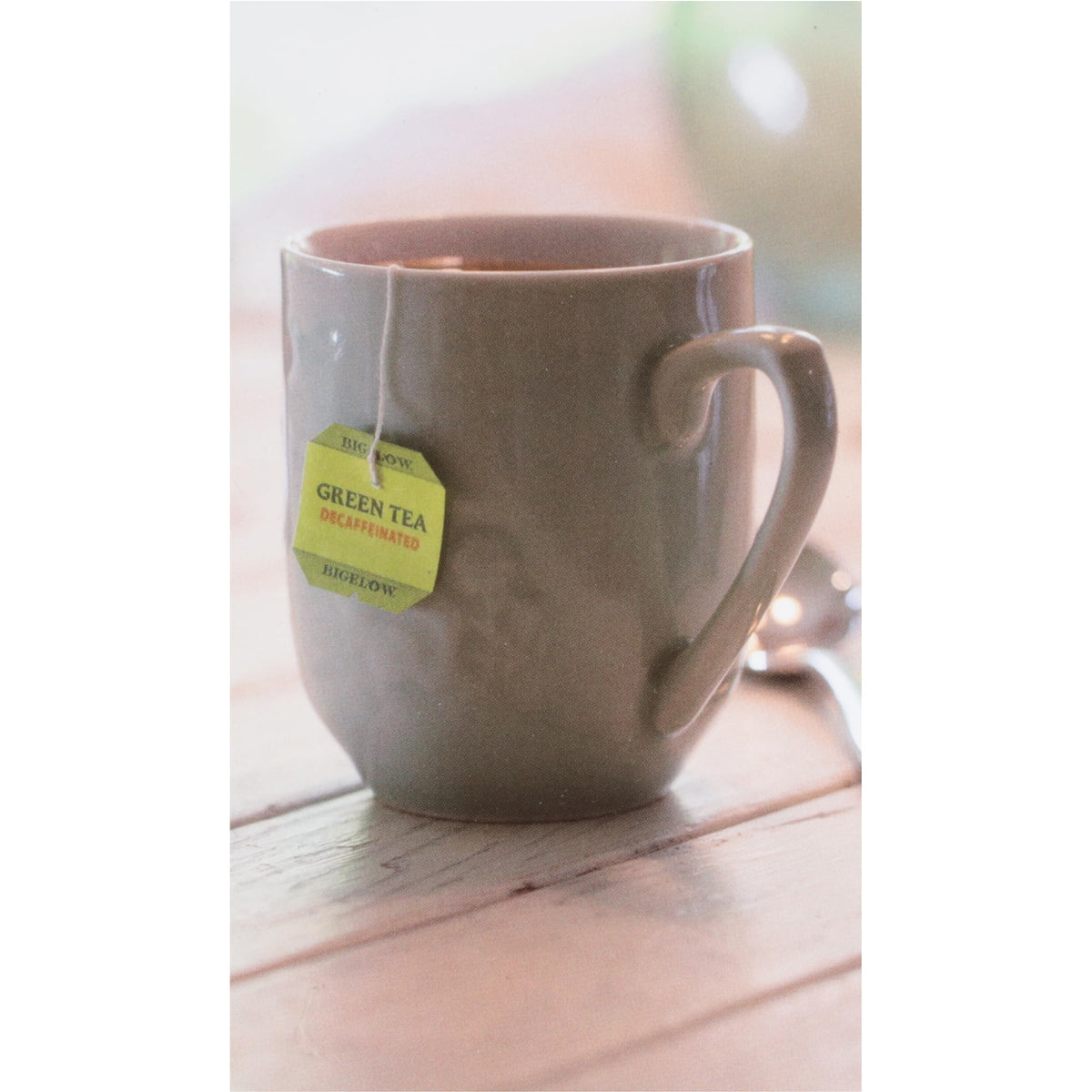 Bigelow Green Tea bags with a steaming cup highlighting smooth flavor for hot or iced tea.