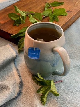 Bigelow peppermint tea bags steeping in cup highlighting refreshing aroma and smooth finish
