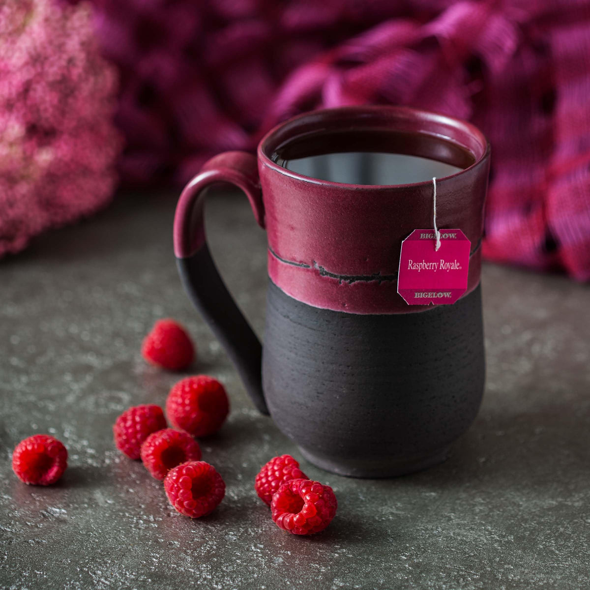Brewing cup of Bigelow Raspberry Royale releases vibrant raspberry notes for a refreshing break.
