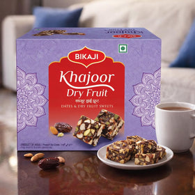 BIKAJI Khajoor Dry Fruit Burfi ingredients close-up featuring dates and nuts.