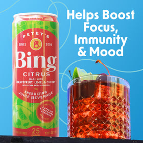 Bing Citrus Energizing Juice Beverage glass with product label emphasizing caffeine and vitamins
