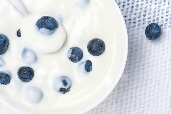 Birch & Meadow Yogurt Powder poured into a smoothie for creamy tang