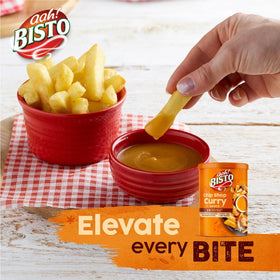 Bisto Chip Shop Curry Sauce Granules being poured from the jar into a pan.