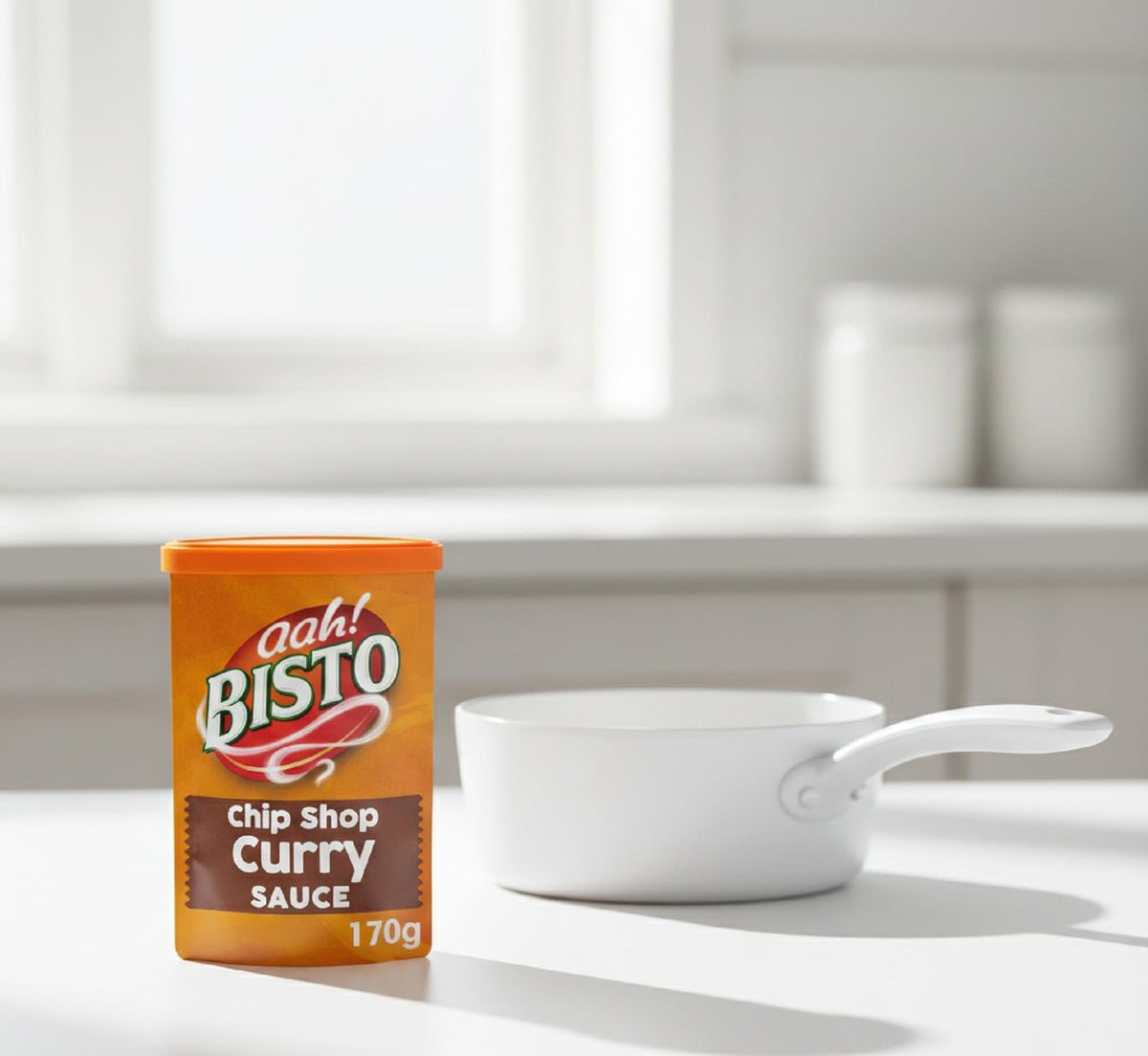 Bisto Chip Shop Curry Sauce Granules pouring into a pan for versatile meals.