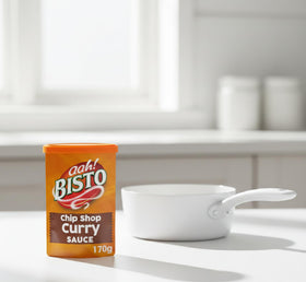 Bisto Chip Shop Curry Sauce Granules pouring into a pan for versatile meals.