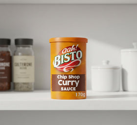 Bisto Chip Shop Curry Sauce Granules close-up, rich texture ready to enhance any dish.