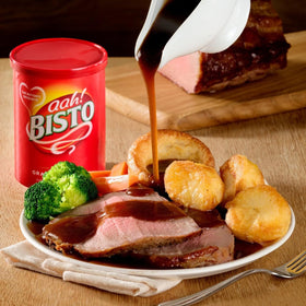 Bisto Gravy Granules being ladled into a bowl for serving.