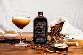 Prepared Espresso Martini in a stemmed glass with coffee bean garnish and Bittermilk.