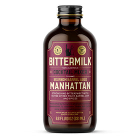 Rustic home bar setup featuring Bittermilk Manhattan mix bottle