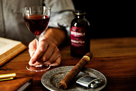 Manhattan glass with brandied cherry garnish and Bittermilk mix