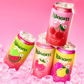 Close-up of Bloom Pop 12oz cans, prebiotic soda for a light, refreshing break.