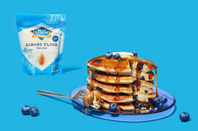 Scoop of Blue Diamond Almond Flour over bowls, highlighting paleo-friendly dessert options.