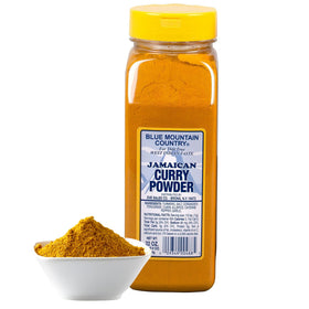 Blue Mountain Country curry powder sizzling in a pan, adding aroma and depth