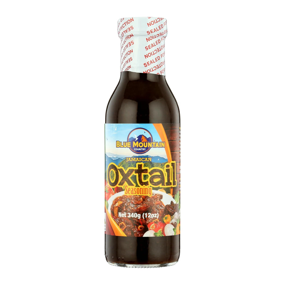 Blue Mountain Country Jamaican Oxtail Seasoning bottle adds authentic Caribbean flavor.