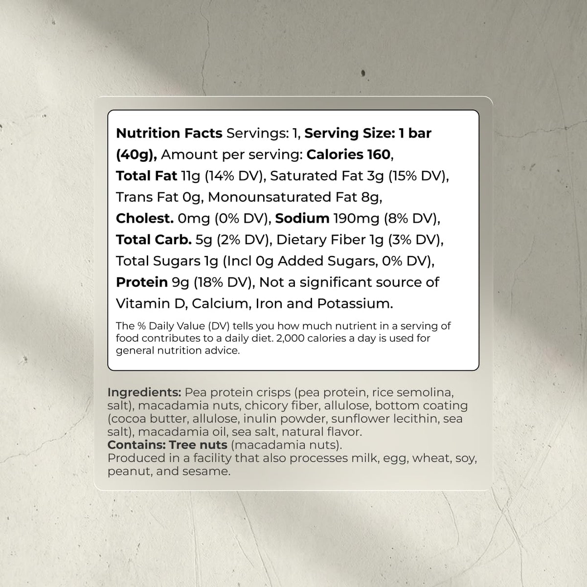 Close-up texture of Blueprint Bryan Johnson macadamia bar with white cocoa and macadamias