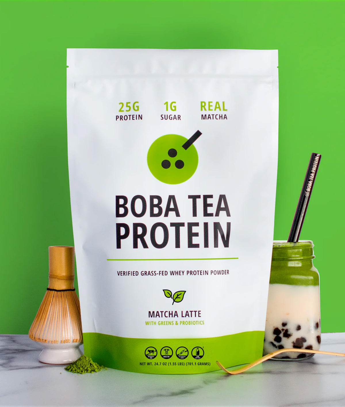 Measuring spoon beside Boba Tea Protein Matcha Latte for precise scooping.