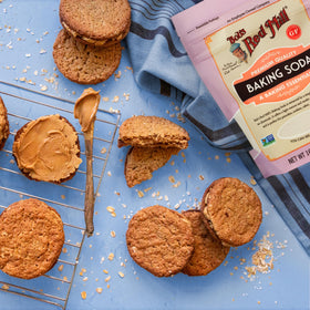 Bob's Red Mill baking soda with cleaning supplies, suggesting deodorizing and cleaning uses.