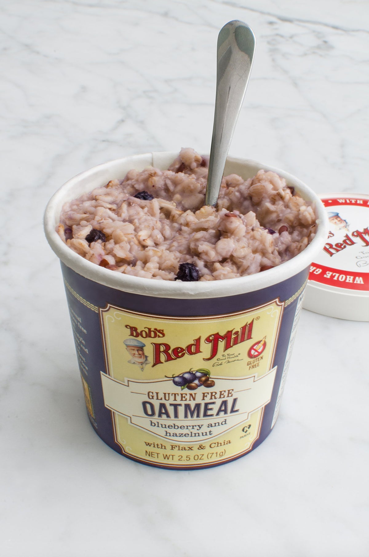 Bob's Red Mill Oatmeal Cup shows blueberries and hazelnuts for a tasty boost.