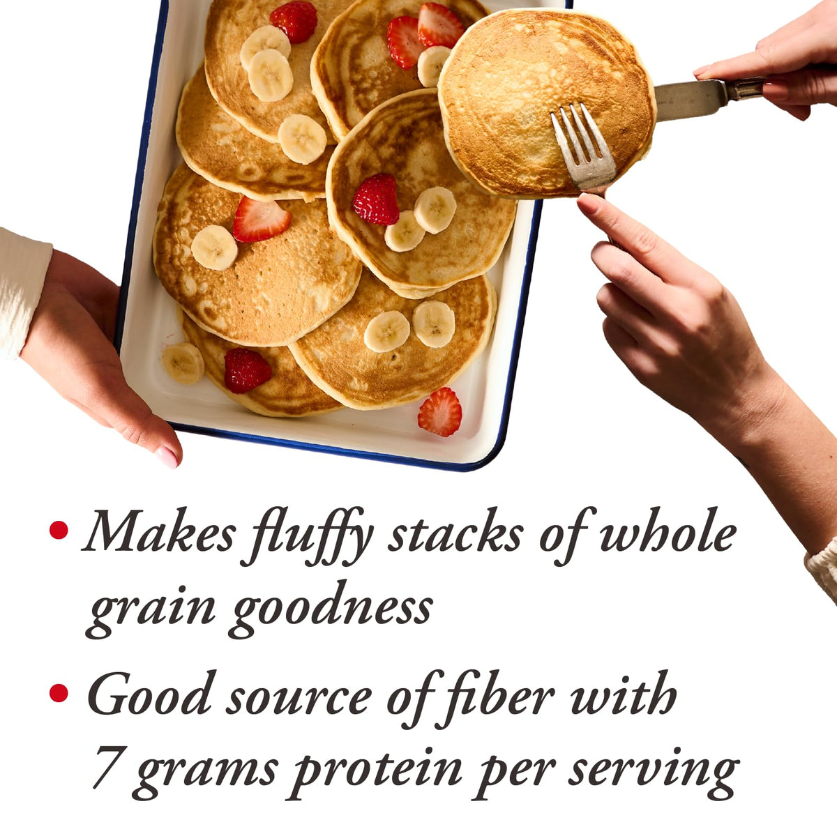 Warm pancakes plated with berries and syrup for serving with Bob's Red Mill.