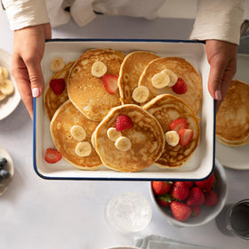 Pancakes cooking on a griddle with Bob's Red Mill mix for golden results.