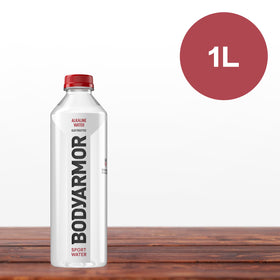 Gym setting with BODYARMOR SportWater bottle on a yoga mat