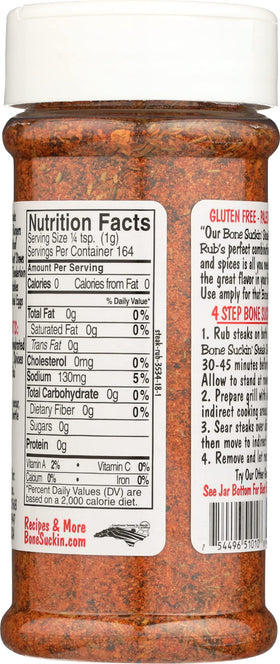 Bone Suckin' Steak Seasoning bottle in use for even coating on meat.