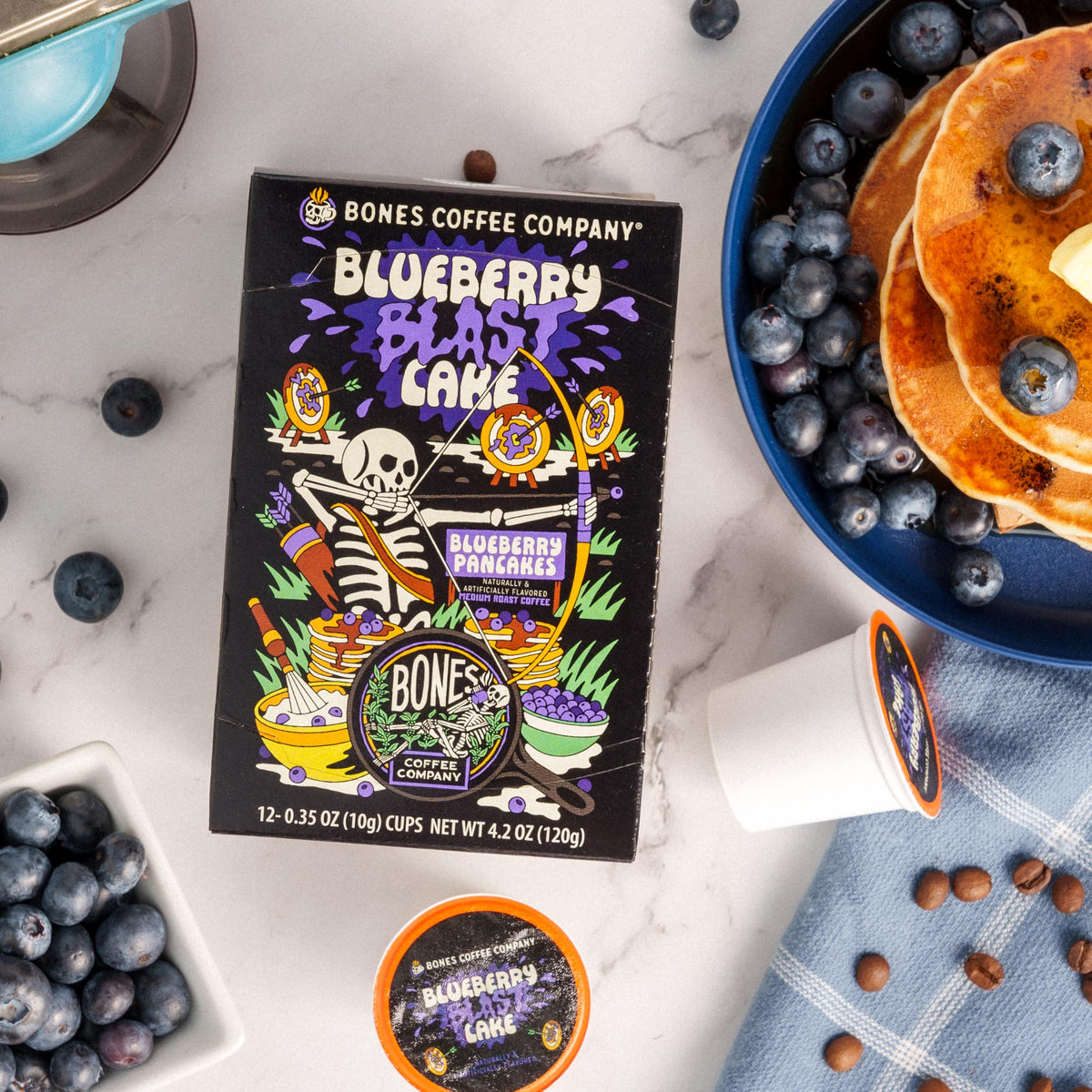 Bones Coffee Blueberry Blast Cake cup close-up with vibrant aroma and low acidity.