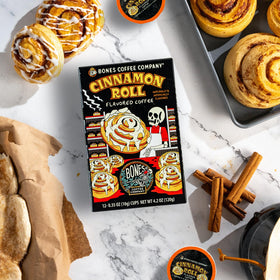 Bones Coffee Company Cinnamon Roll Pod close-up, showing Keurig 1.0 and 2.0 compatibility.