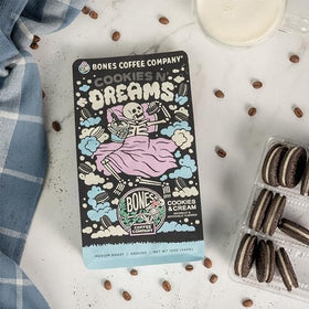 Pouring Cookies 'N Dreams coffee with rich crema in a mug