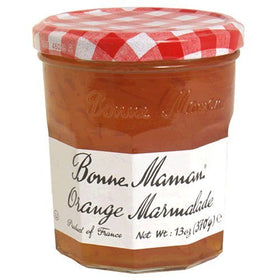 Close-up of Bonne Maman orange marmalade in a glass jar with vibrant color.