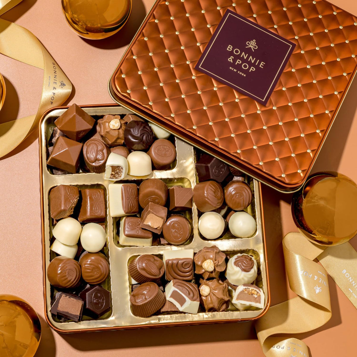 Assorted milk, dark and white truffles in a Bonnie & Pop luxury box.