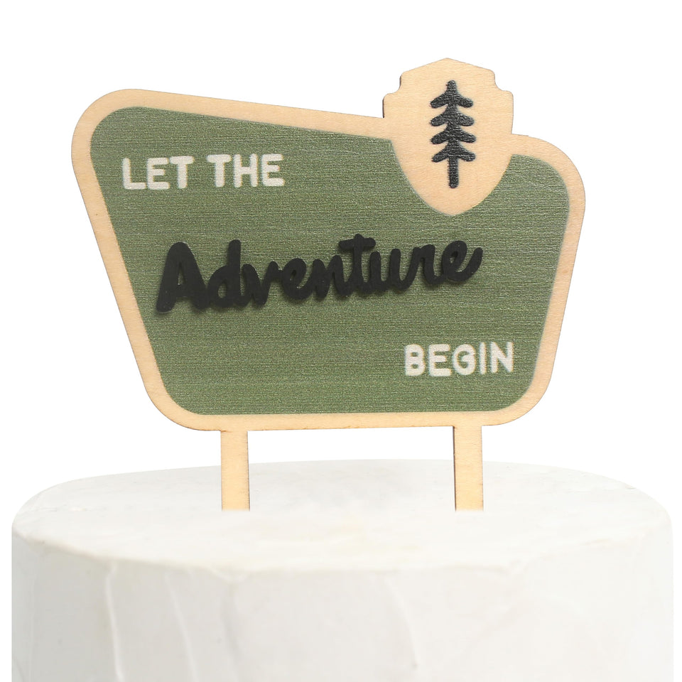 BOOMPA Let the Adventure Begin cake topper on baby's birthday cake for lasting memories.