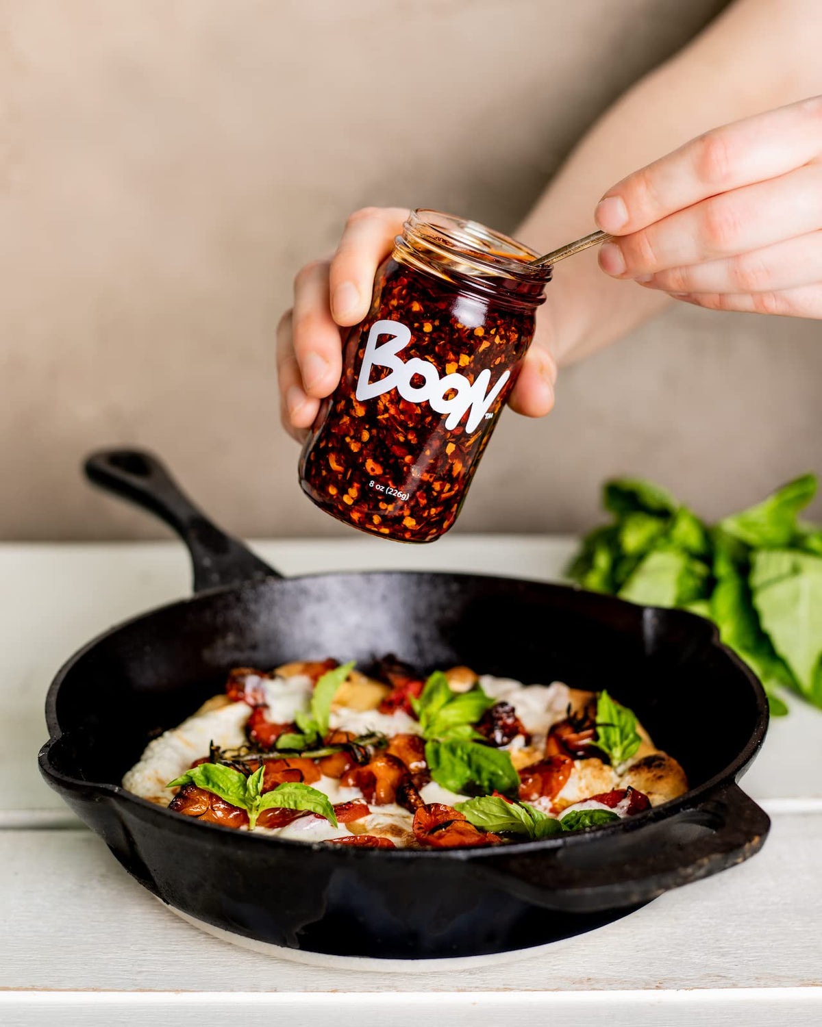 Boon Sauce Chili Oil ingredients close-up with chilis, garlic, anchovy.