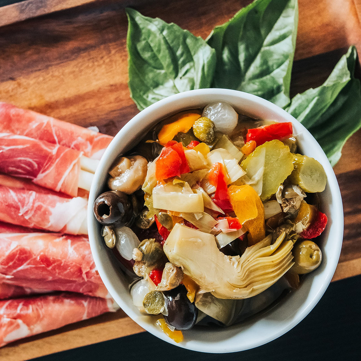 Botticelli antipasto jar ingredients artichoke, olives, mushrooms arranged for tasting