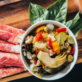 Botticelli antipasto jar ingredients artichoke, olives, mushrooms arranged for tasting