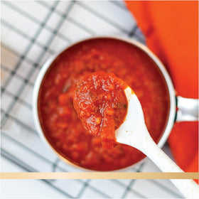 Family dinner with Botticelli sauce and vibrant tomatoes on the table.