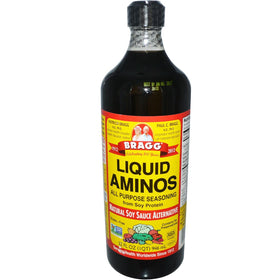 Bragg Liquid Aminos bottle pouring, a savory alternative to soy sauce for meats and veggies.