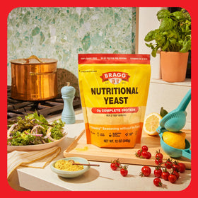 Bragg Premium Nutritional Yeast Seasoning sprinkled over roasted vegetables for flavor boost.