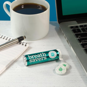 Breath Savers Wintergreen mints on a desk for easy access during work.