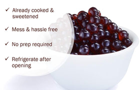 Close-up of bursting blueberry pearls releasing juice for bubble tea.